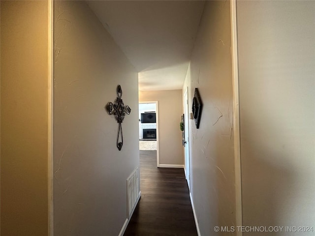 corridor with dark hardwood / wood-style floors