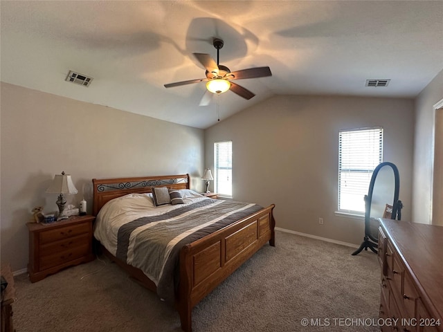 bedroom featuring ceiling fan, light colored carpet, multiple windows, and vaulted ceiling