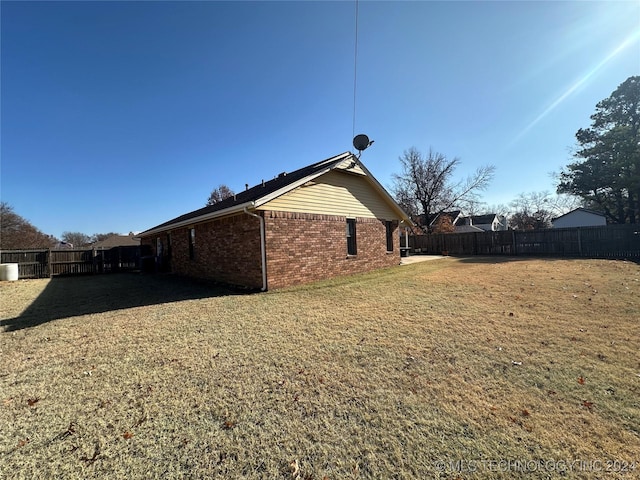 view of side of home featuring a lawn