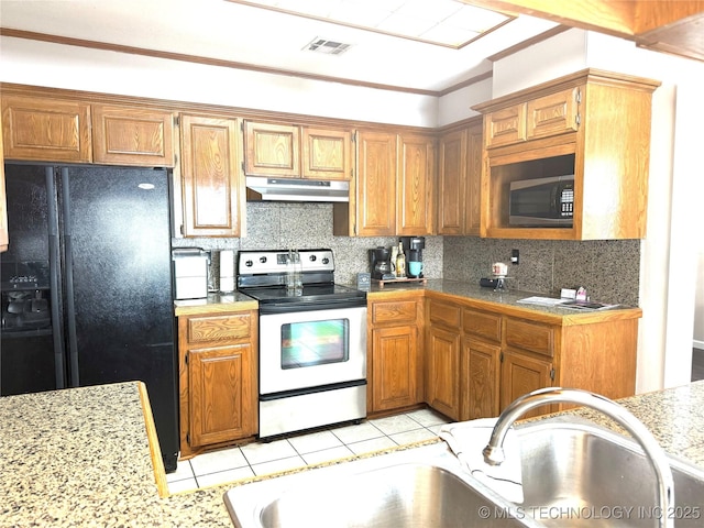 kitchen with sink, black appliances, tasteful backsplash, and light tile patterned floors