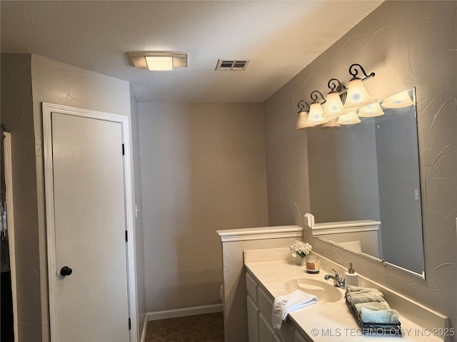 bathroom featuring vanity and a textured ceiling