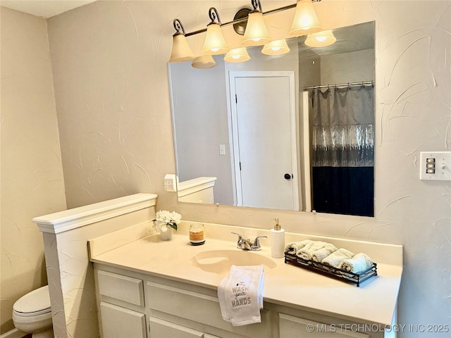 bathroom with toilet and vanity