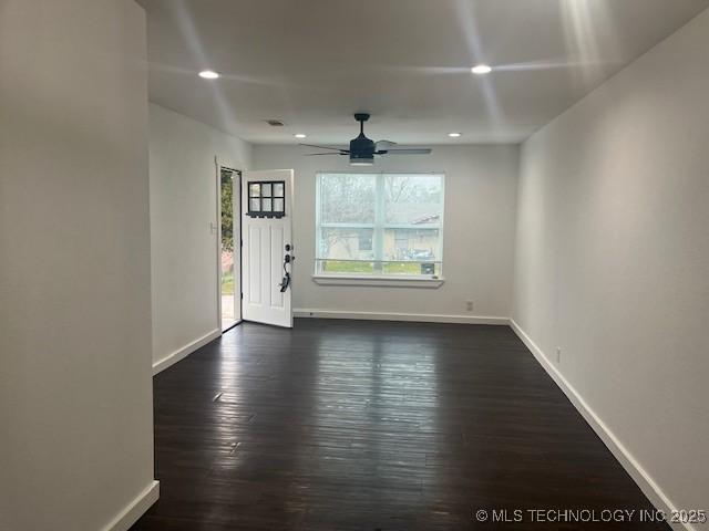 interior space featuring recessed lighting, baseboards, and dark wood-style floors