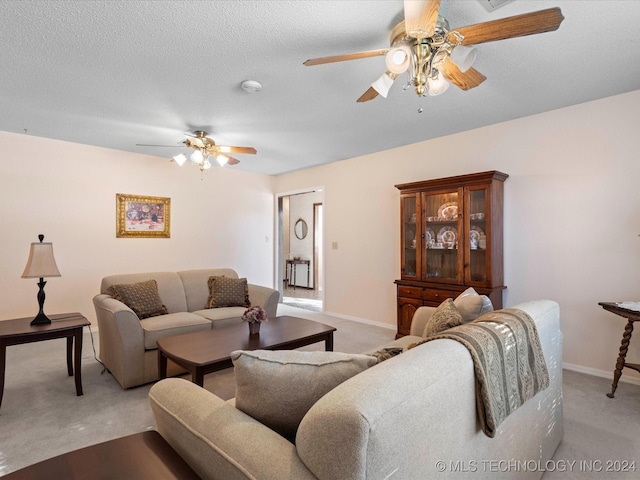 carpeted living room with ceiling fan and a textured ceiling