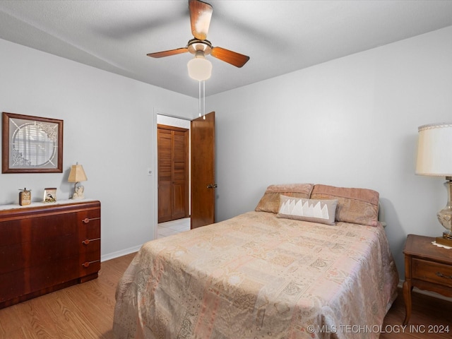 bedroom with ceiling fan and light hardwood / wood-style flooring