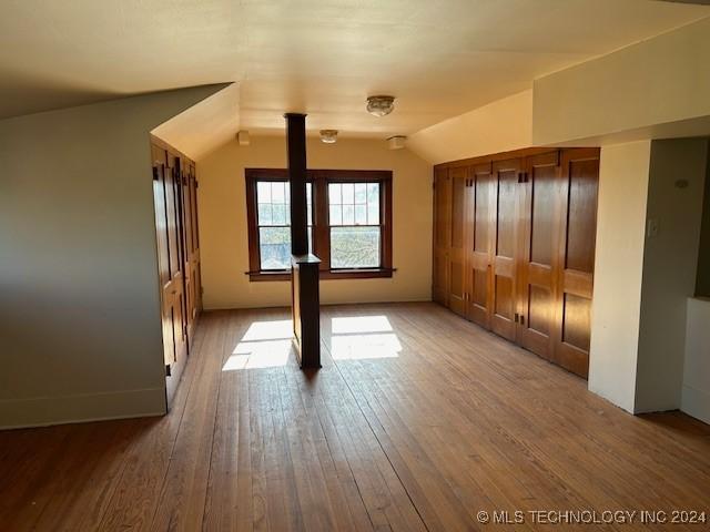 interior space with wood-type flooring and lofted ceiling