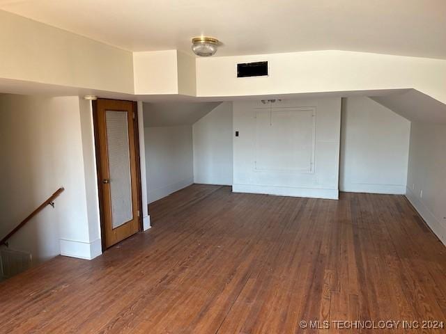 bonus room with dark hardwood / wood-style flooring and lofted ceiling