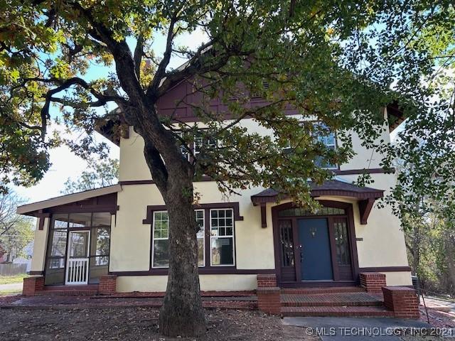 view of front of home with a sunroom