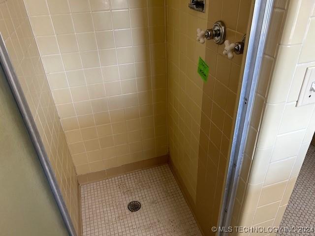 bathroom with tiled shower