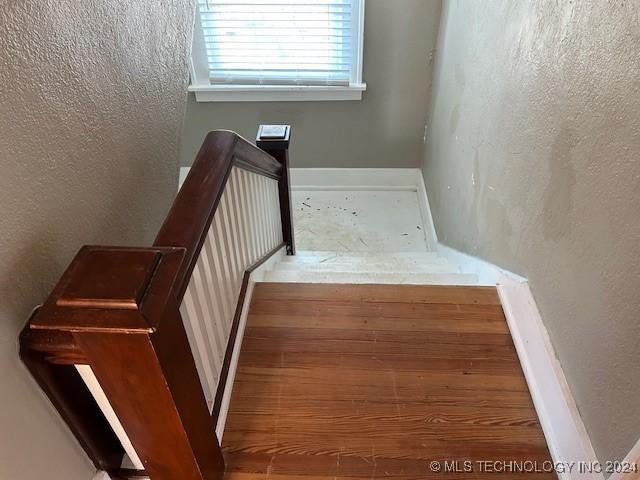 stairs with hardwood / wood-style flooring