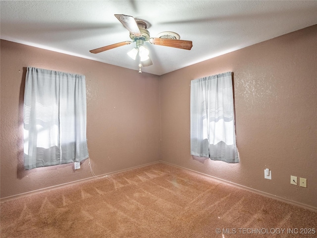 unfurnished room featuring ceiling fan and carpet flooring