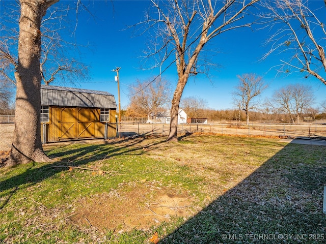 view of yard with an outbuilding and a rural view