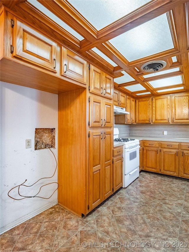 kitchen featuring beamed ceiling, coffered ceiling, and white gas stove