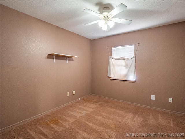 empty room featuring ceiling fan, carpet flooring, and a textured ceiling