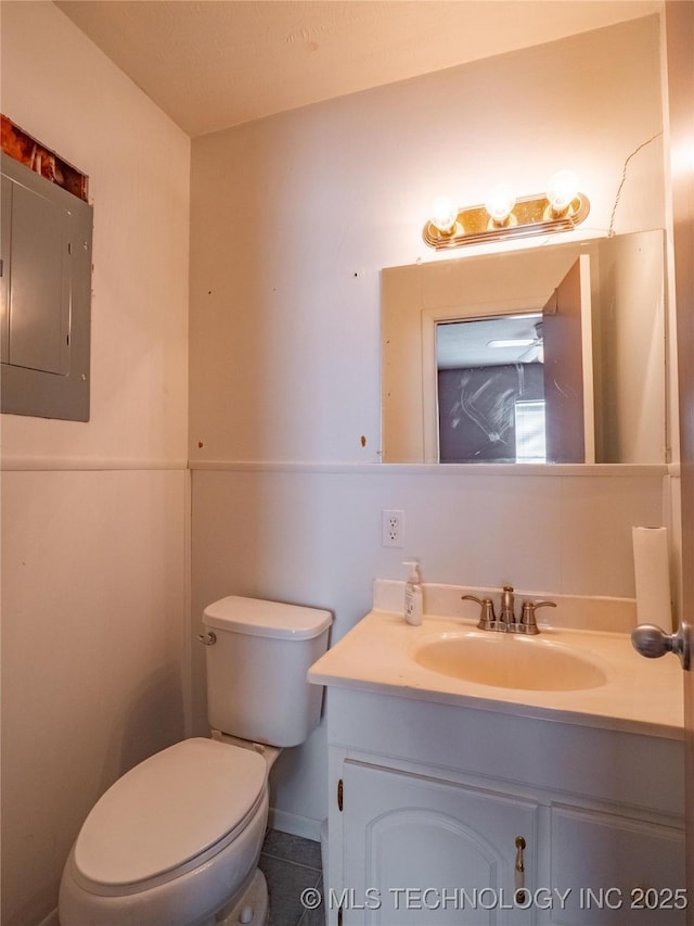 bathroom with vanity, tile patterned flooring, electric panel, and toilet