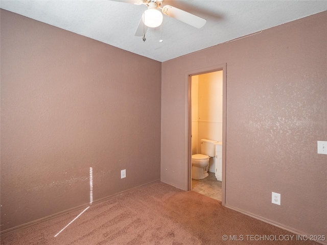 unfurnished bedroom featuring ceiling fan, connected bathroom, and carpet floors