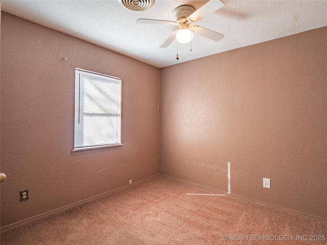 carpeted spare room featuring ceiling fan