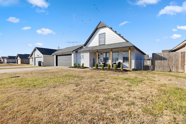 view of front of house with covered porch, a front yard, and a garage