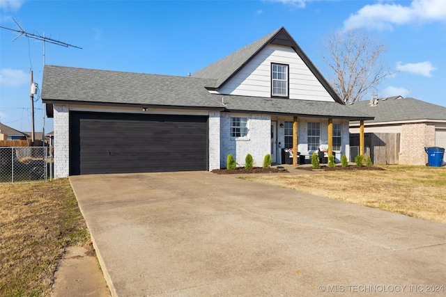 view of front of property featuring covered porch and a garage