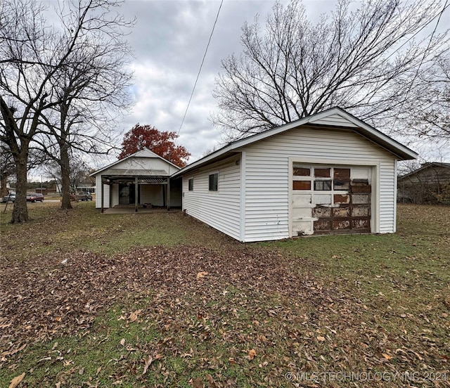 exterior space with an outbuilding and a garage