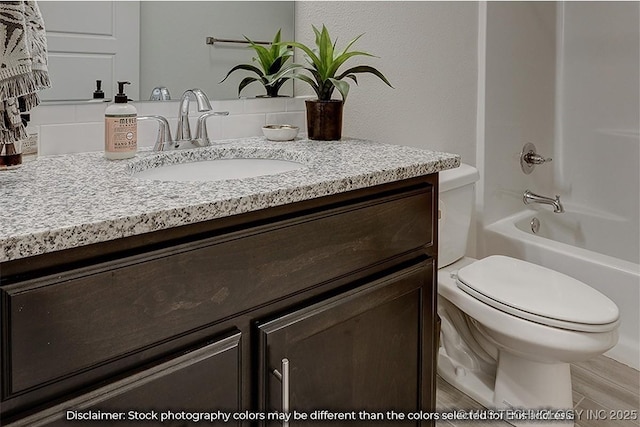 full bathroom with tub / shower combination, vanity, and toilet