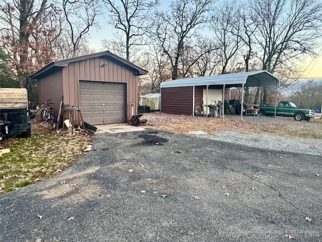 garage at dusk with a carport