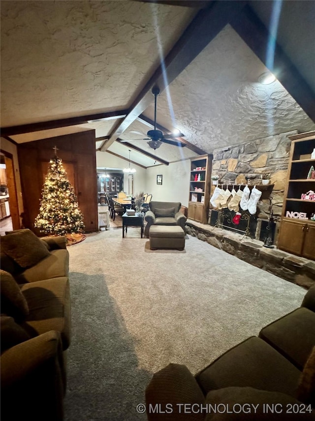 carpeted living room with a stone fireplace, ceiling fan, built in features, and lofted ceiling with beams