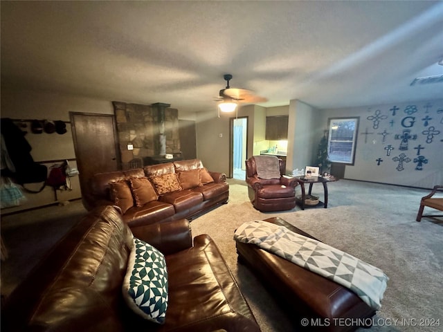 carpeted living room with ceiling fan and a textured ceiling