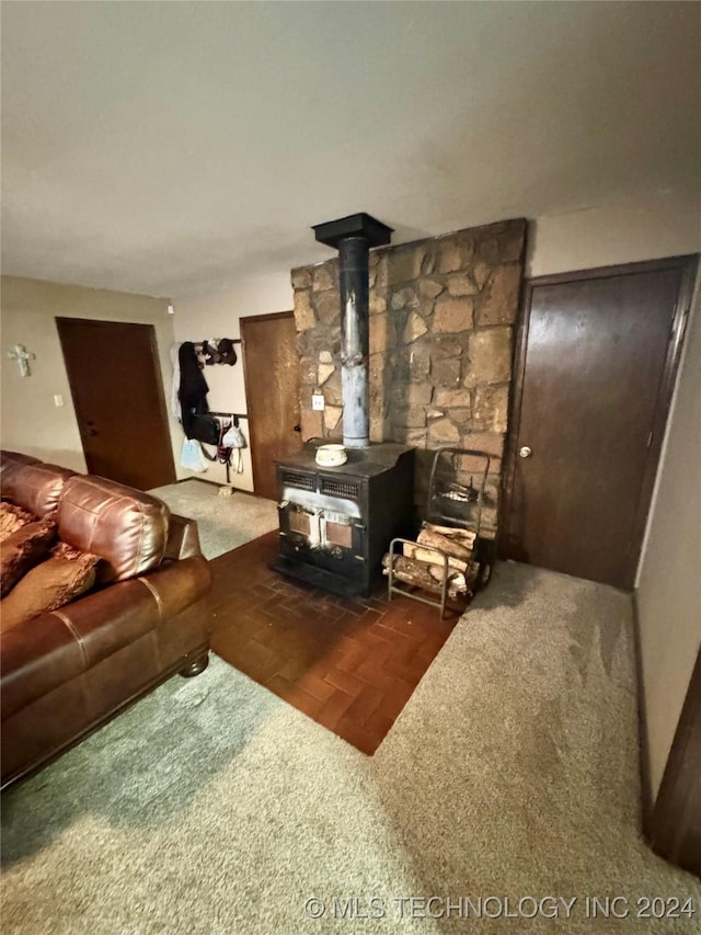 7750 River Ridge Rd, Muskogee, OK 74403 - living room featuring a wood stove and carpet flooring