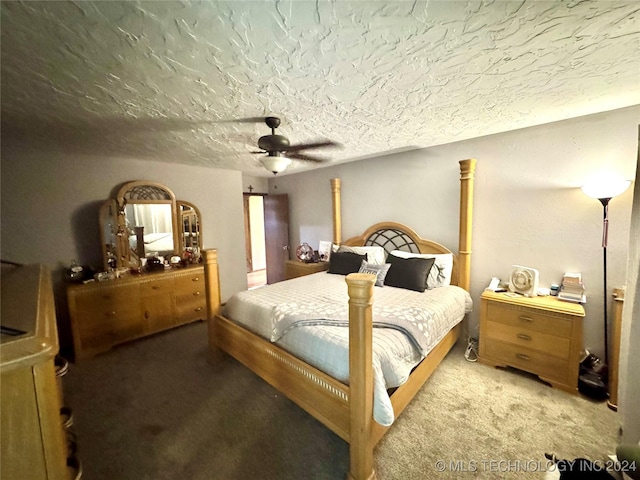 bedroom with carpet, a textured ceiling, and ceiling fan