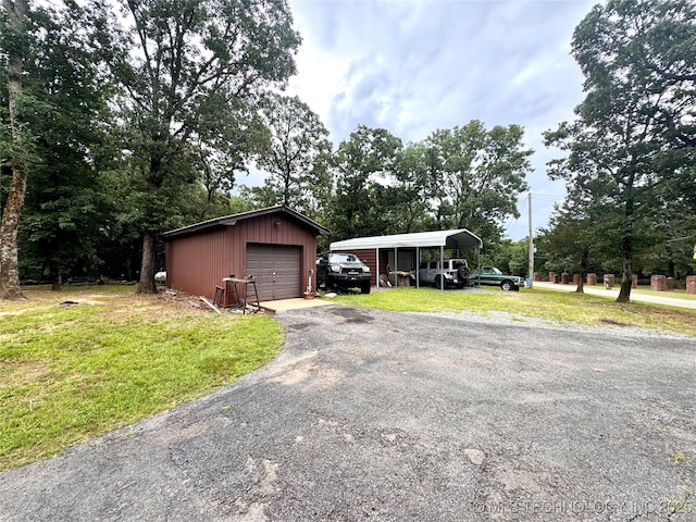 7750 River Ridge Rd, Muskogee, OK 74403 - view of front facade with an outdoor structure, a front lawn, a detached garage, and asphalt driveway