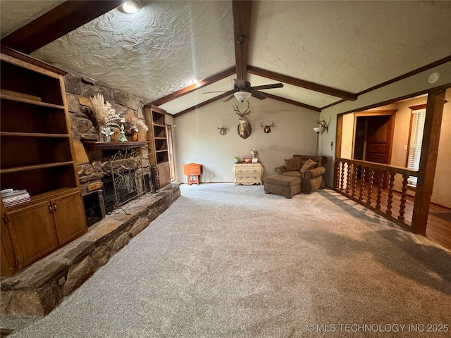 7750 River Ridge Rd, Muskogee, OK 74403 - carpeted living area featuring ceiling fan, a fireplace, and a textured ceiling