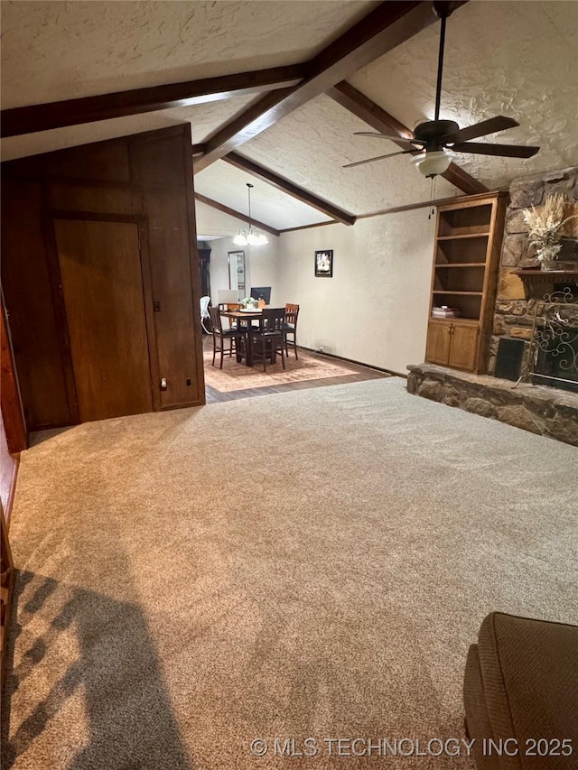 7750 River Ridge Rd, Muskogee, OK 74403 - carpeted living area featuring a ceiling fan, a textured ceiling, a chandelier, and a fireplace