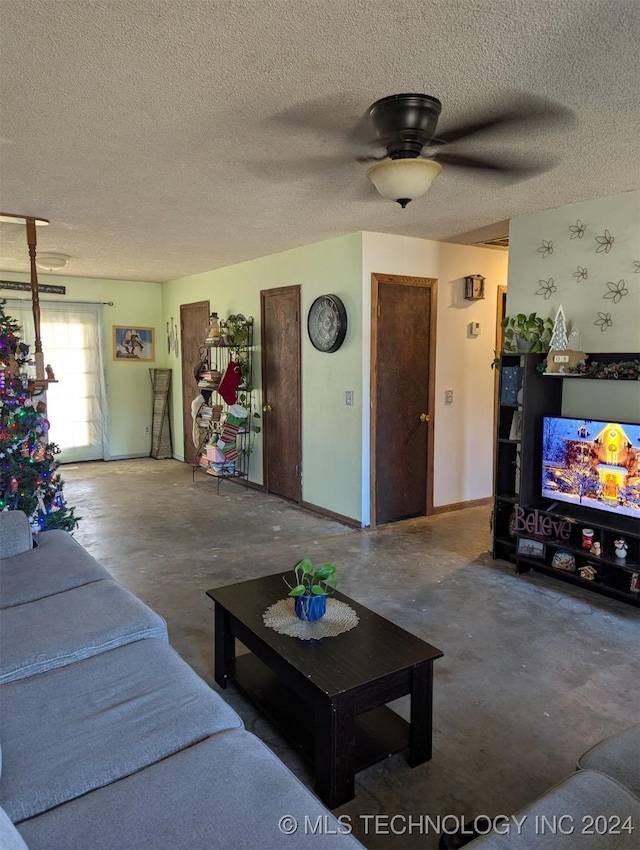 living room with ceiling fan, concrete flooring, and a textured ceiling