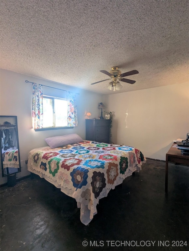 bedroom featuring concrete floors, ceiling fan, and a textured ceiling