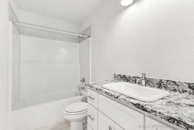 full bathroom featuring washtub / shower combination, vanity, toilet, and tile patterned flooring