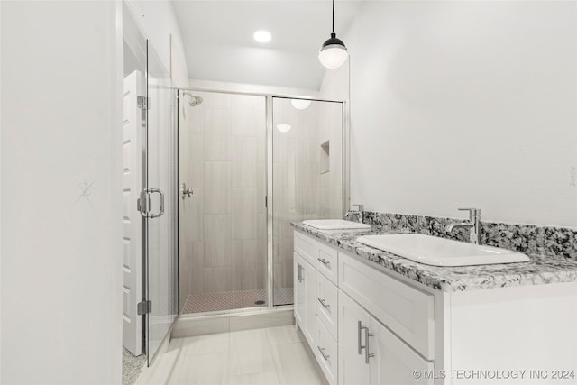 bathroom with a shower with door and vanity