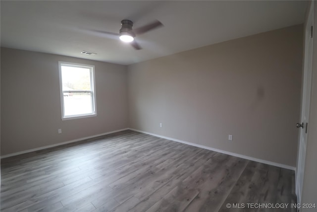 empty room with ceiling fan and hardwood / wood-style flooring