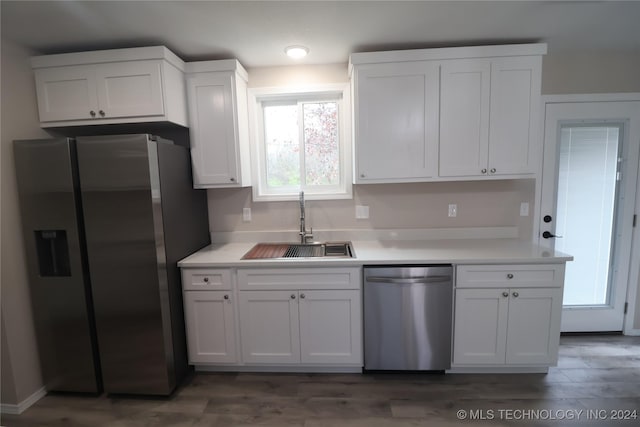 kitchen featuring appliances with stainless steel finishes, dark hardwood / wood-style floors, white cabinetry, and sink