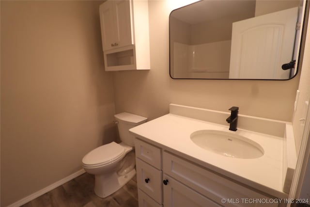 bathroom featuring hardwood / wood-style flooring, vanity, and toilet