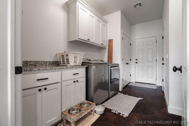 laundry room featuring cabinets and independent washer and dryer