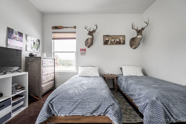 bedroom featuring dark colored carpet