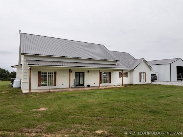 view of front of property featuring french doors and a front lawn