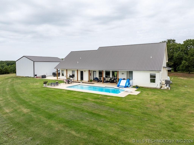 rear view of property with a lawn and a patio area