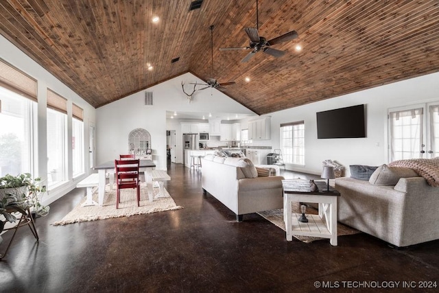 living room with wooden ceiling, high vaulted ceiling, and a healthy amount of sunlight