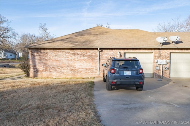 view of side of home featuring a garage