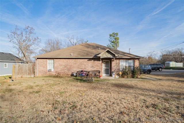 ranch-style home with a front lawn