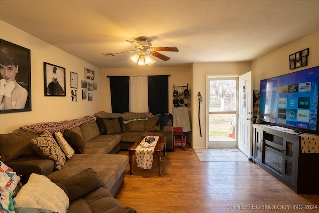 living room with wood-type flooring and ceiling fan