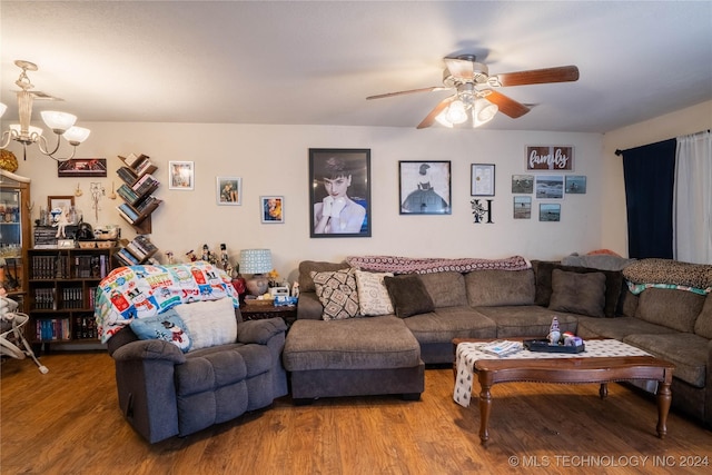 living room featuring ceiling fan with notable chandelier and hardwood / wood-style flooring