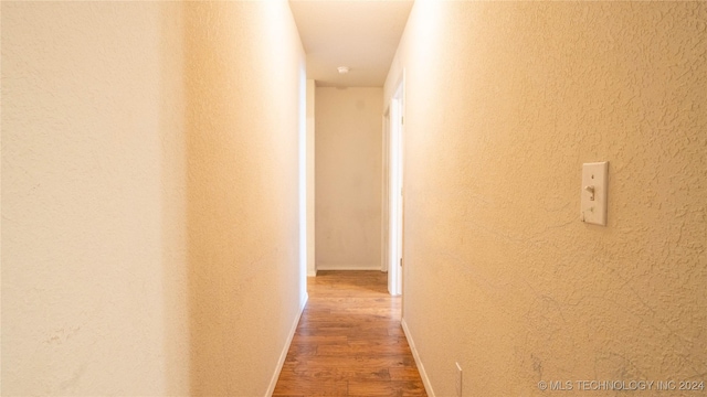 corridor featuring wood-type flooring